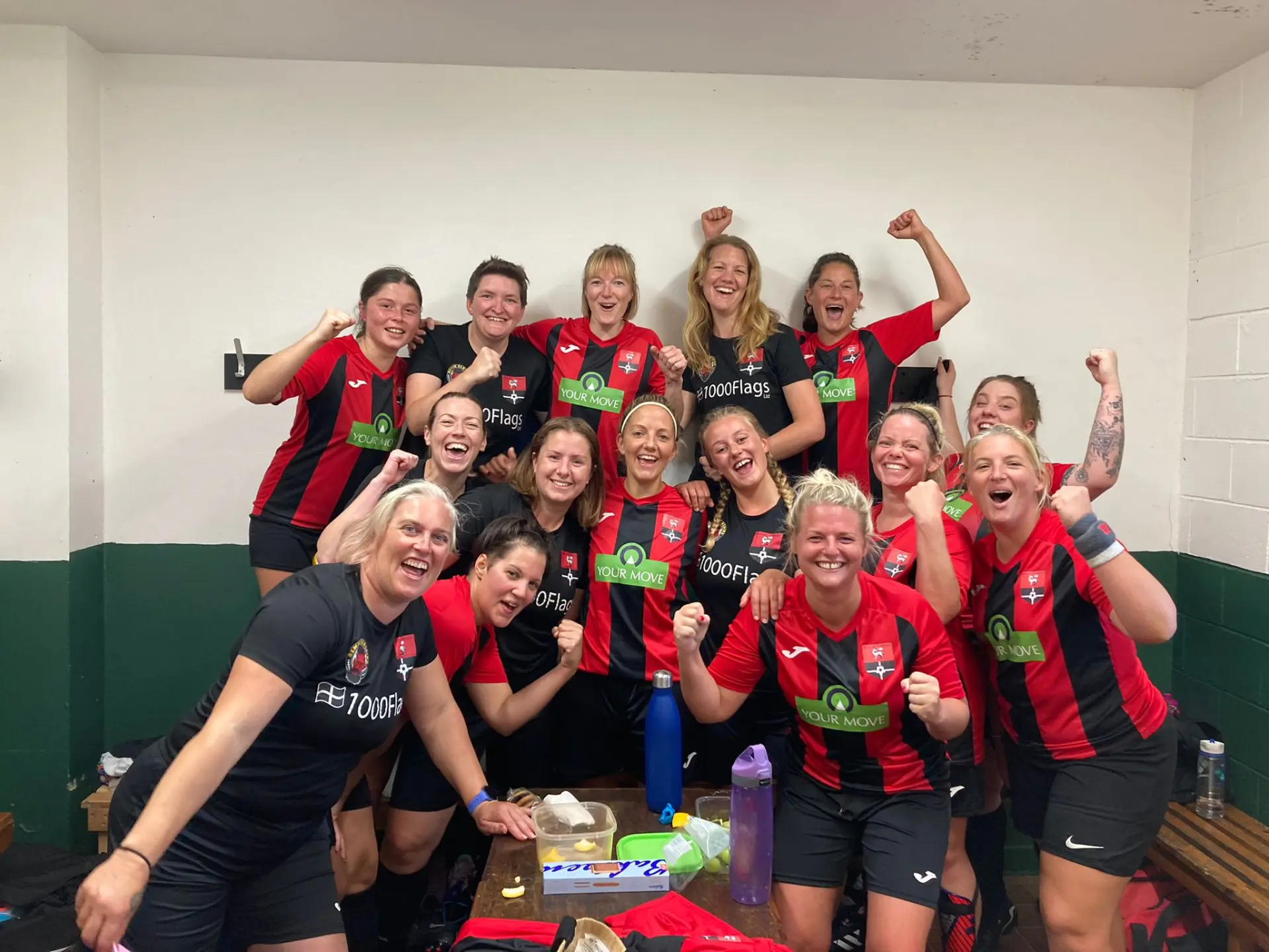 Redruth United women's team celebrating in the changing room after a win