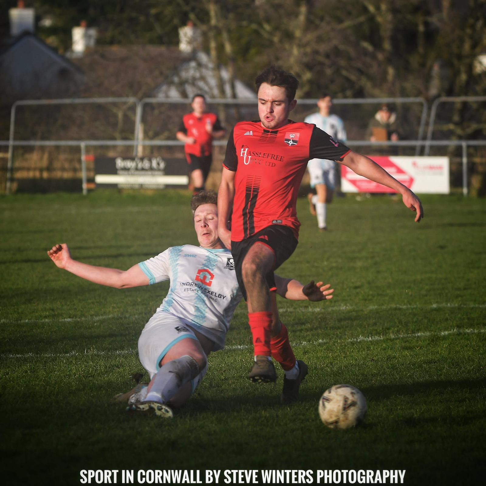 Redruth United men's player riding a tackle in a league match