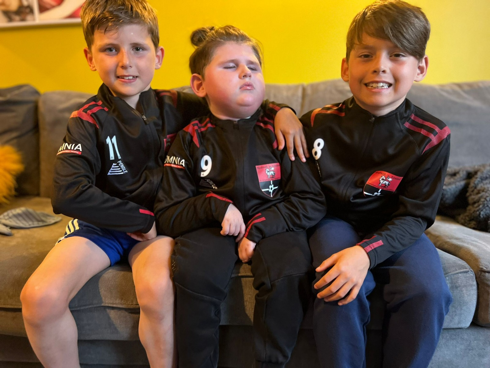 Jude with his two big brothers in Redruth United tracksuits